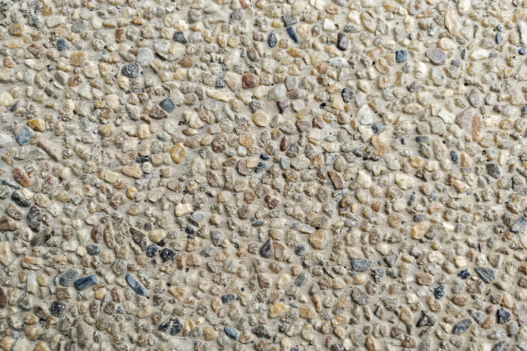 Close-up of exposed aggregate driveway with visible pebbles and textures.