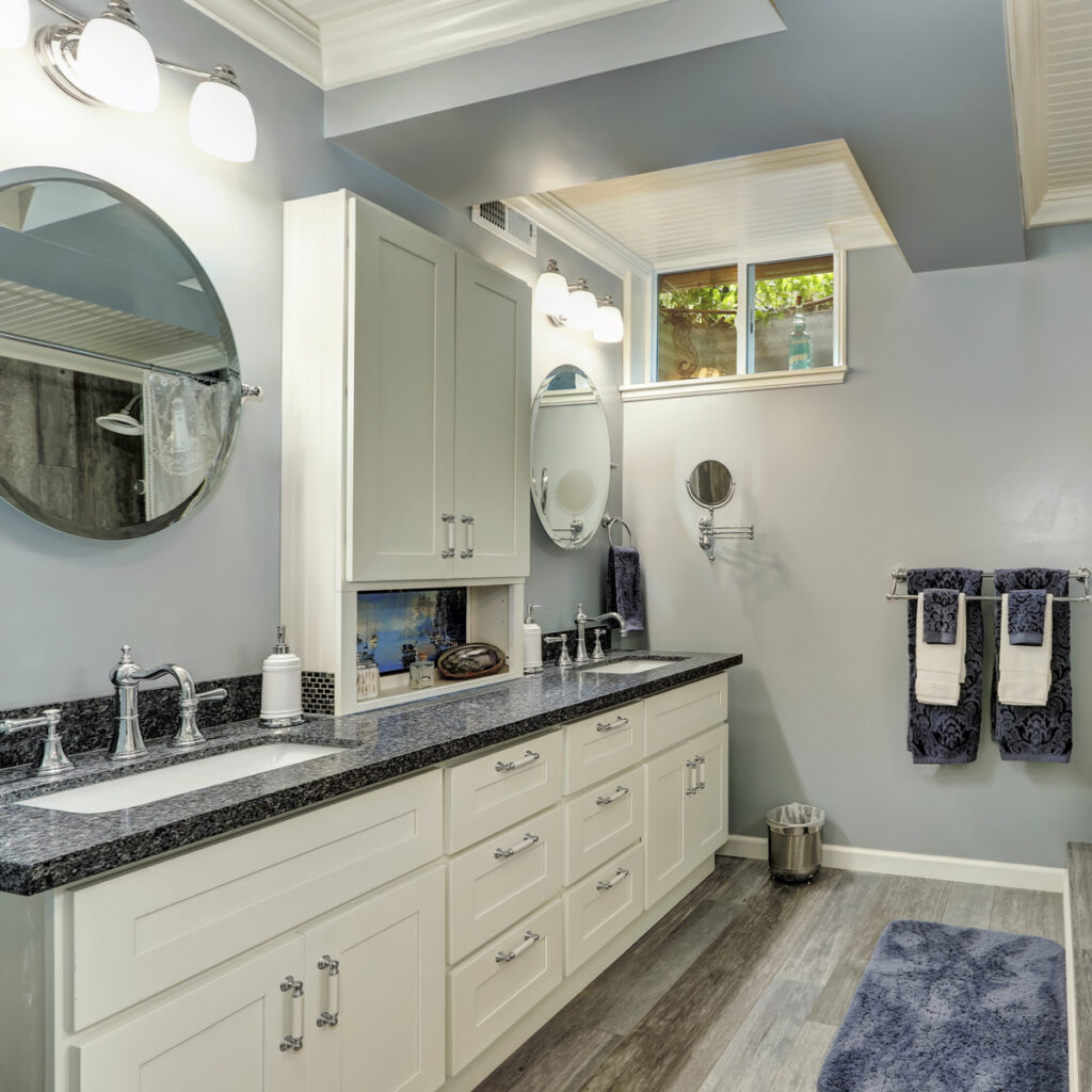 Spacious basement bathroom with dual vanity and modern fixtures.
