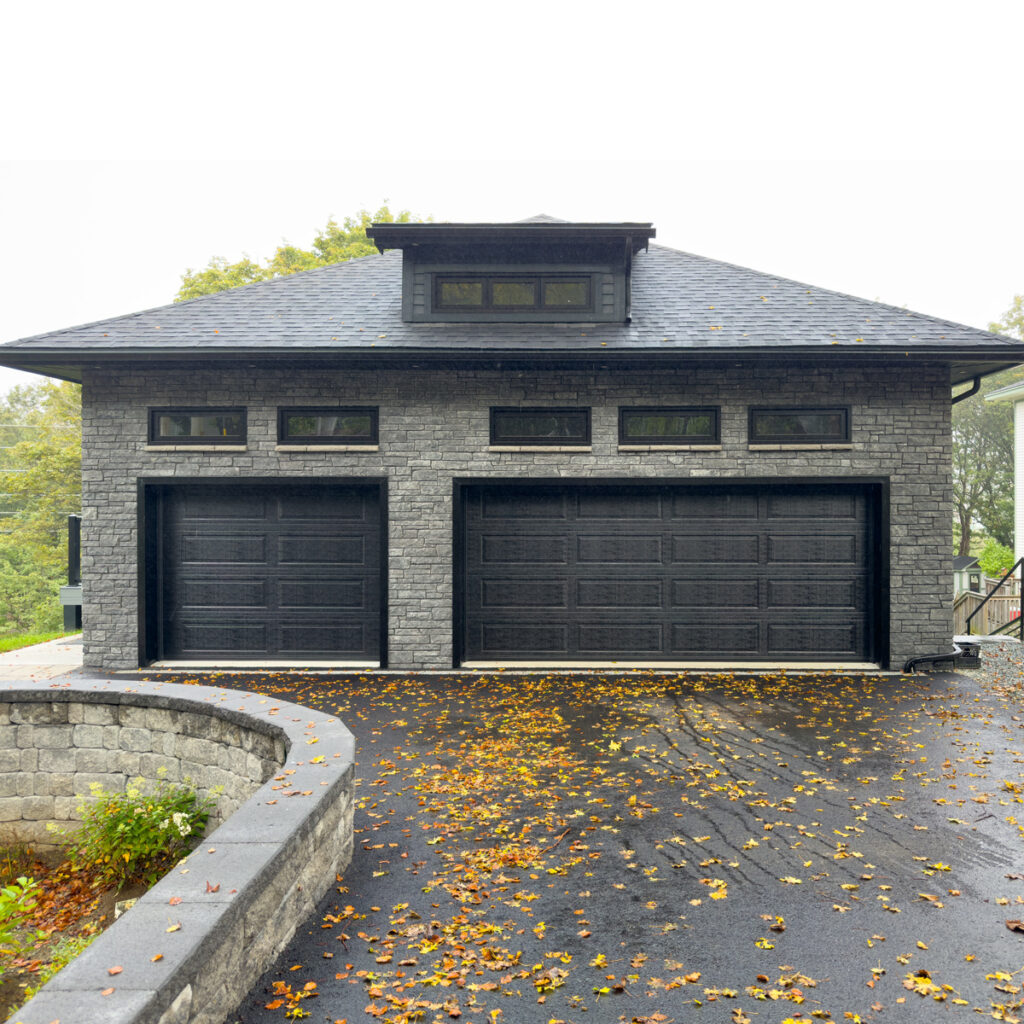Garage Addition Northern Virginia with double doors and autumn leaves on driveway.