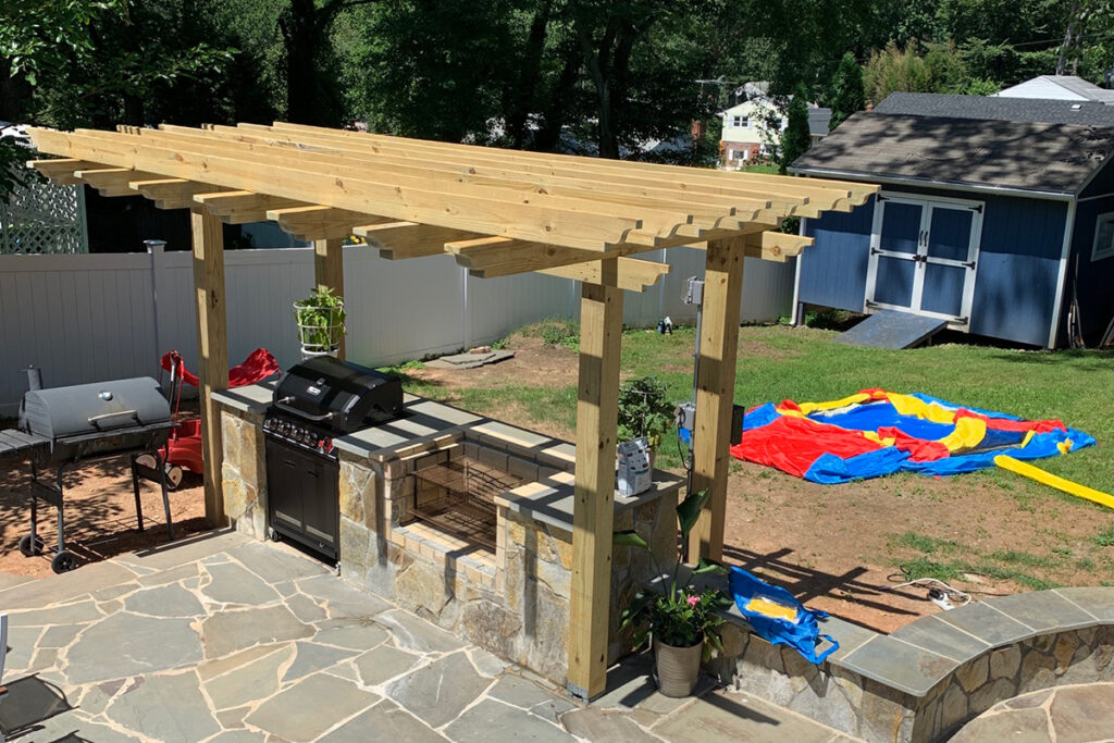 Completed flagstone patio with outdoor kitchen and pergola