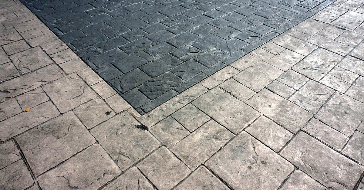 Close-up of stamped concrete driveway with contrasting integrated colors.